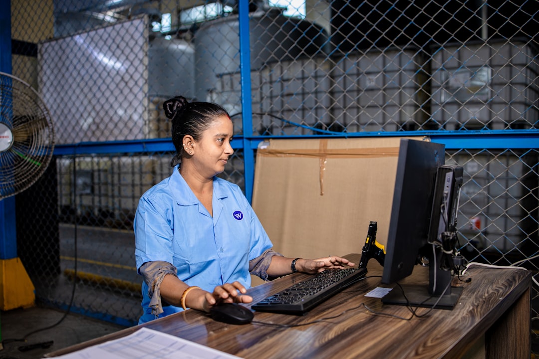 Supply chain professional studying for APICS certification with logistics data displayed on screen