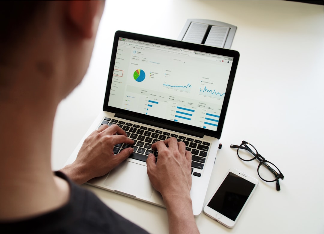 Professional studying for data analytics certification with charts and data dashboards