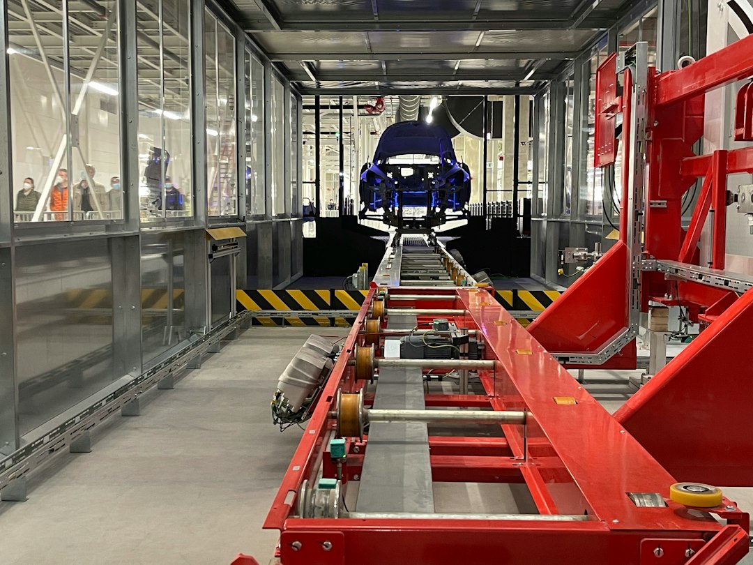 SolidWorks 3D CAD model of an automotive component displayed on an engineer workstation